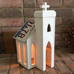 Rustic white antique church with license plate roof.