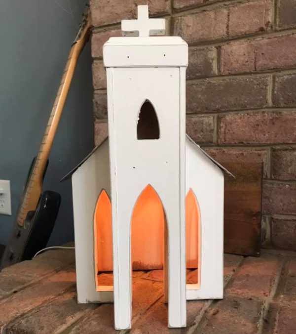 Rustic white antique church with license plate roof.